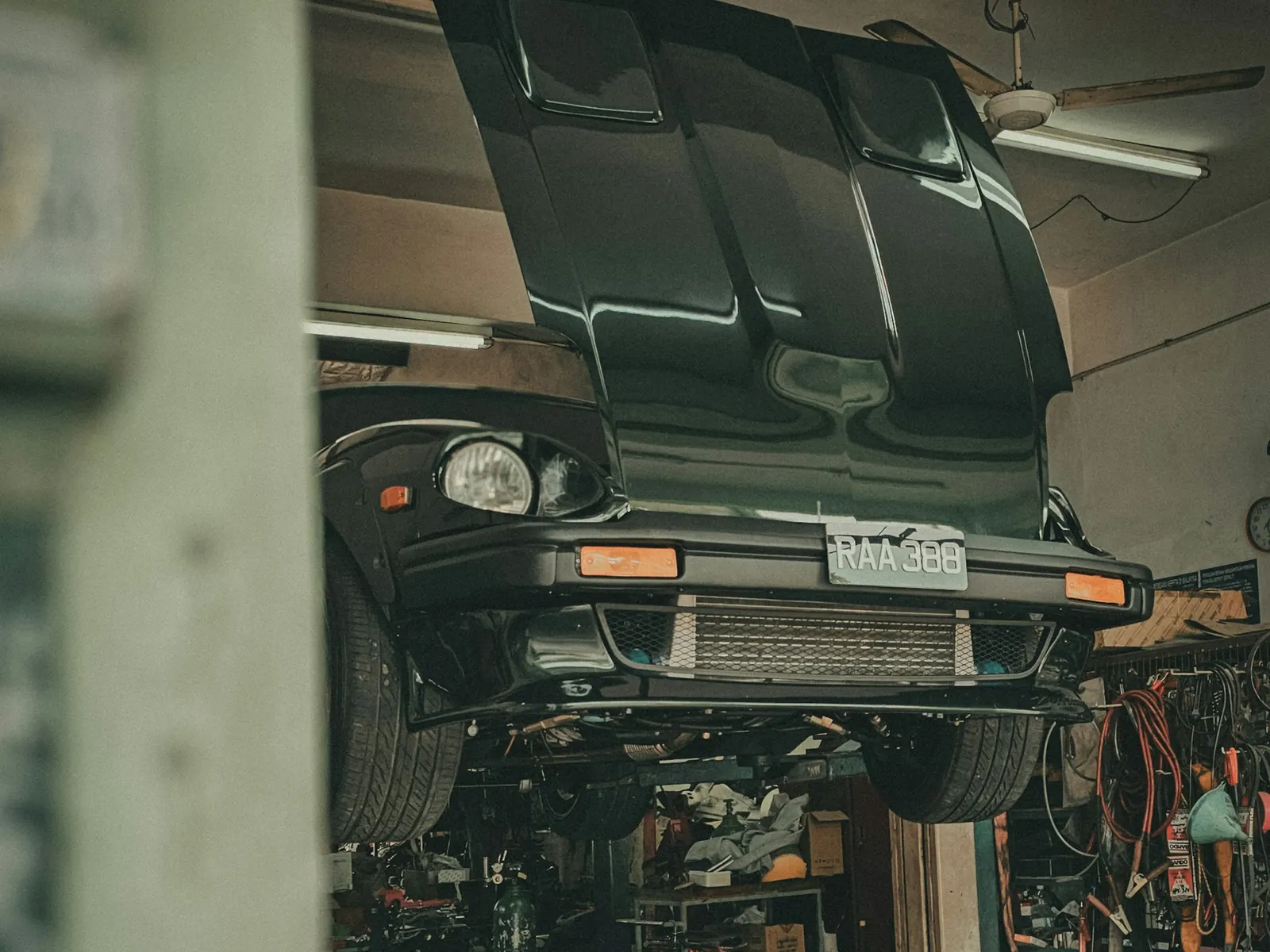 Car raised on a lift inside a repair shop