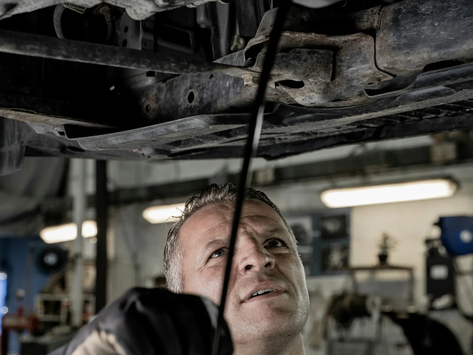 Mechanic working under a car